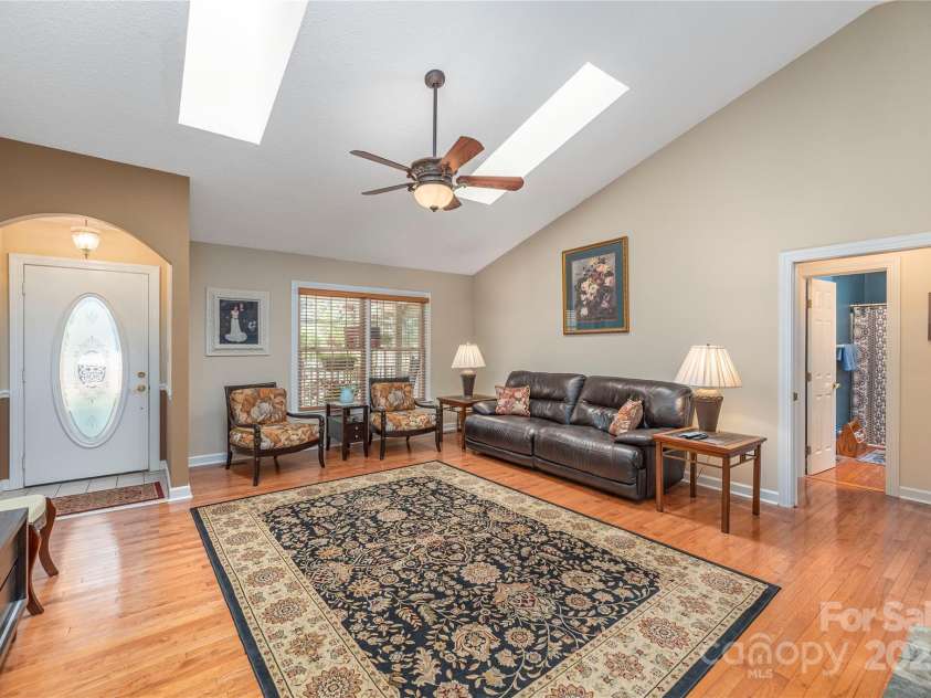 24 Moriah Lane, Asheville, NC 28803.  MLS# CAR4277809, YatesRealty ID 28686. Great room with hardwood floors and vaulted ceilings