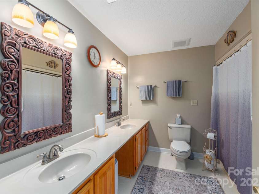 24 Moriah Lane, Asheville, NC 28803.  MLS# CAR4277809, YatesRealty ID 28686. Primary suite bathroom with double sinks