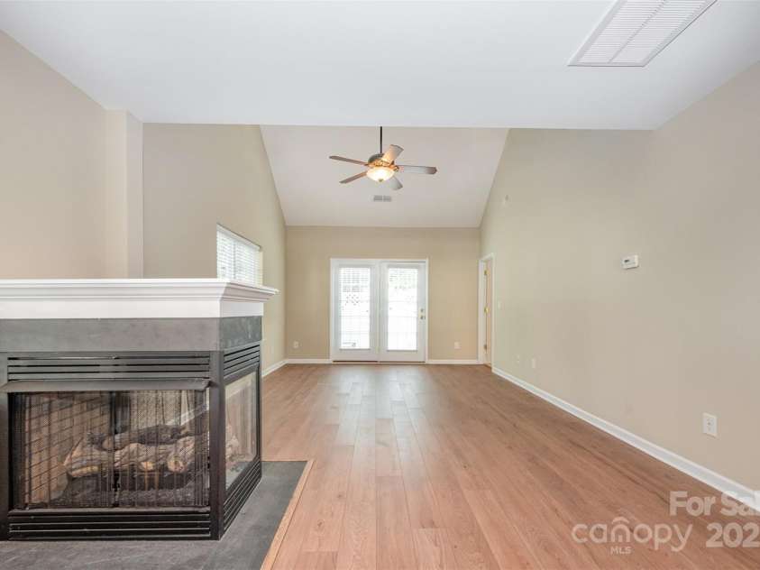 11921 Lambert Bridge Drive, Charlotte, NC 28270.  MLS# CAR4282578, YatesRealty ID 28698. Gas fireplace between dining area and family room