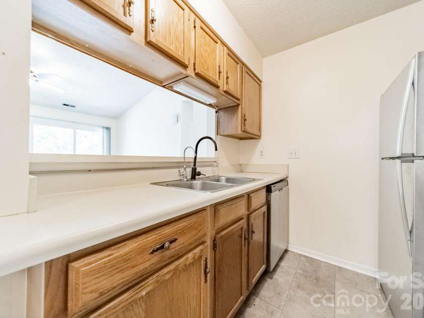 9605 Vinca Circle, Charlotte, NC 28213.  MLS# CAR4385047, YatesRealty ID 28719. Kitchen with window over the sink and stainless refrigerator