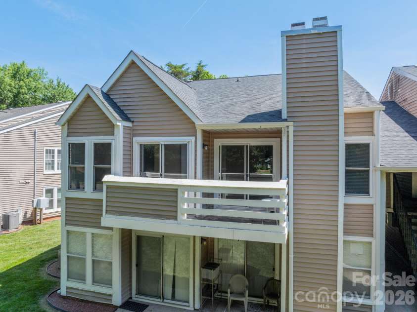9605 Vinca Circle, Charlotte, NC 28213.  MLS# CAR4385047, YatesRealty ID 28719. Side exterior with brick fireplace chimney