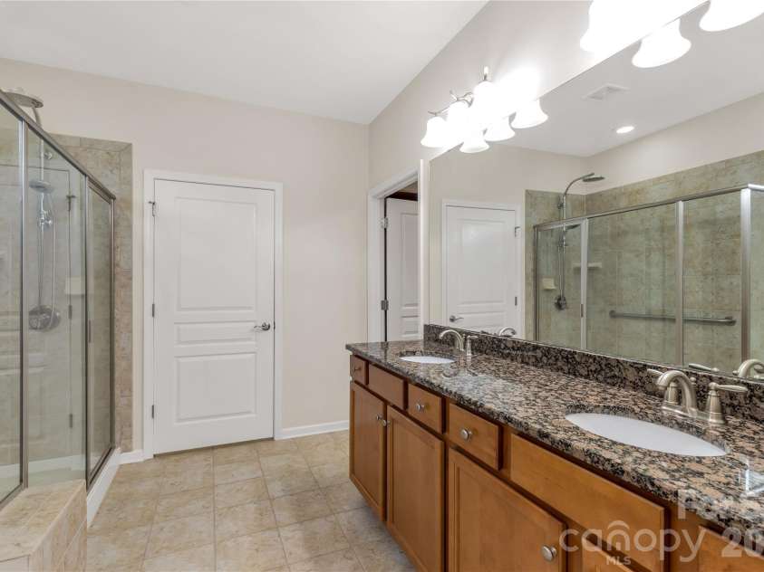 1079 Falling Leaf Street, Indian Land, SC 29707.  MLS# CAR4313558, YatesRealty ID 28772. Primary bathroom with dual vanity and large walk in shower