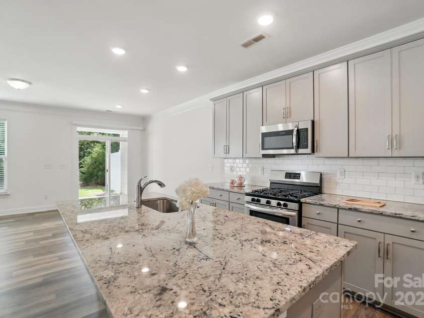 8018 Saluda Drive, Charlotte, NC 28269.  MLS# CAR4255269, YatesRealty ID 28789. Tiled backsplash, walk-in pantry, and abundant cabinetry make this kitchen a dream.