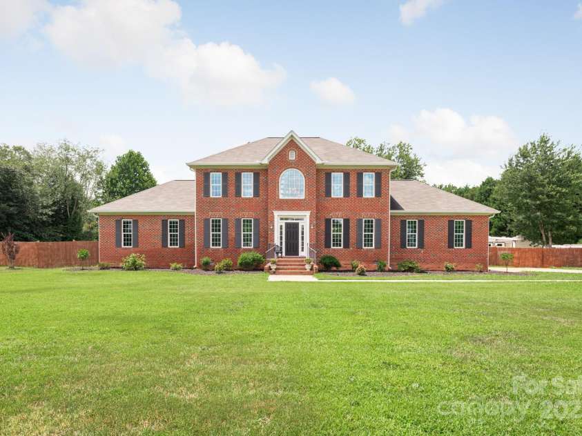168 Harwell Road, Mooresville, NC 28117.  MLS# CAR4282323, YatesRealty ID 28807. Front of home inside the front metal gated area