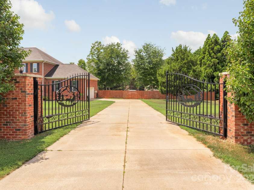 168 Harwell Road, Mooresville, NC 28117.  MLS# CAR4282323, YatesRealty ID 28807. Gated Estate entrance