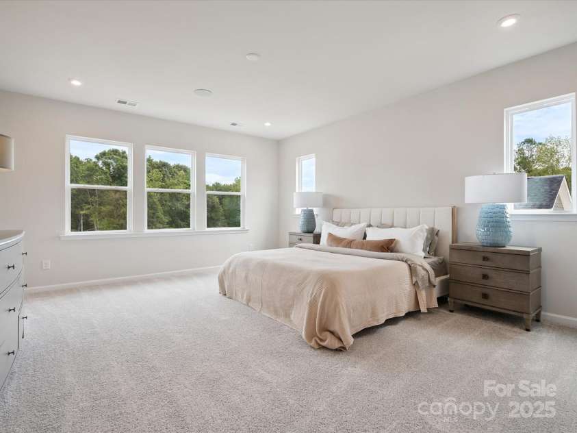 619 Webster Lane, Cramerton, NC 28032.  MLS# CAR4322006, YatesRealty ID 2881. Generously Sized Primary Suite Surrounded by Windows and Unobstructed Views.  *Model Photos | Actual Finishes, Structural Selections, and Orientation May Vary.