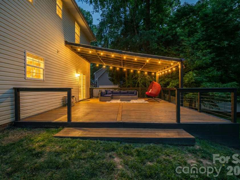 9027 Leah Meadow Lane, Charlotte, NC 28227.  MLS# CAR4384401, YatesRealty ID 28817. Evening oasis on the back deck overlooking backyard