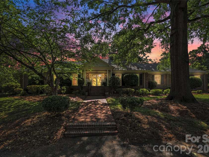 930 Scotch Drive, Gastonia, NC 28054.  MLS# CAR4385001, YatesRealty ID 28831. Twilight view highlighting the home’s timeless charm