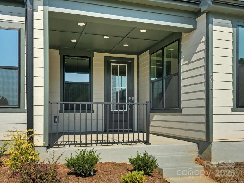 323 Ardmore Drive, Belmont, NC 28012.  MLS# CAR4319122, YatesRealty ID 28845. Cozy Covered Front Porch With Modern Black Railing.