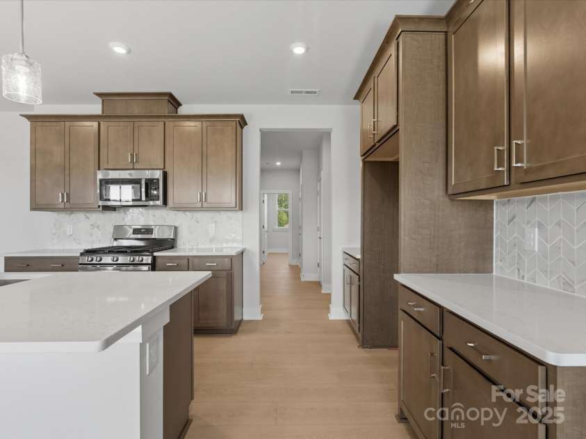 323 Ardmore Drive, Belmont, NC 28012.  MLS# CAR4319122, YatesRealty ID 28845. Modern Stained, Wood-Toned Cabinets Bring Warmth to the Space.