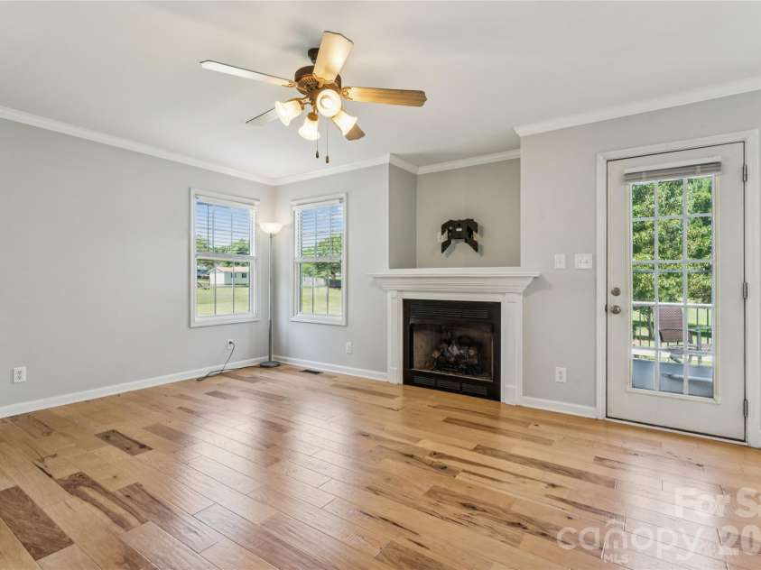 246 Maple Ridge Circle, Salisbury, NC 28147.  MLS# CAR4390588, YatesRealty ID 28849. Cozy fireplace with door leading to deck