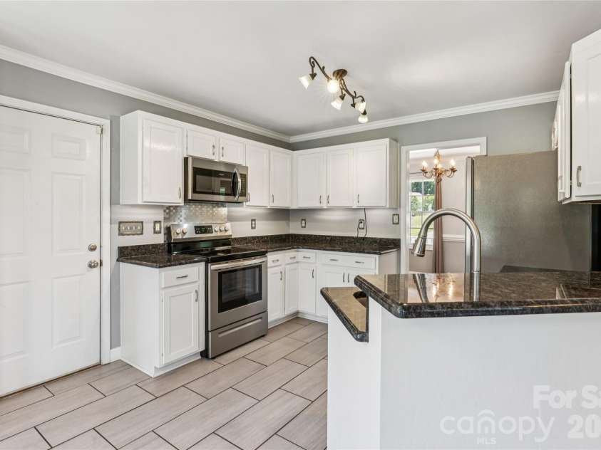 246 Maple Ridge Circle, Salisbury, NC 28147.  MLS# CAR4390588, YatesRealty ID 28849. Kitchen  - garage entry to the left and dining to the right
