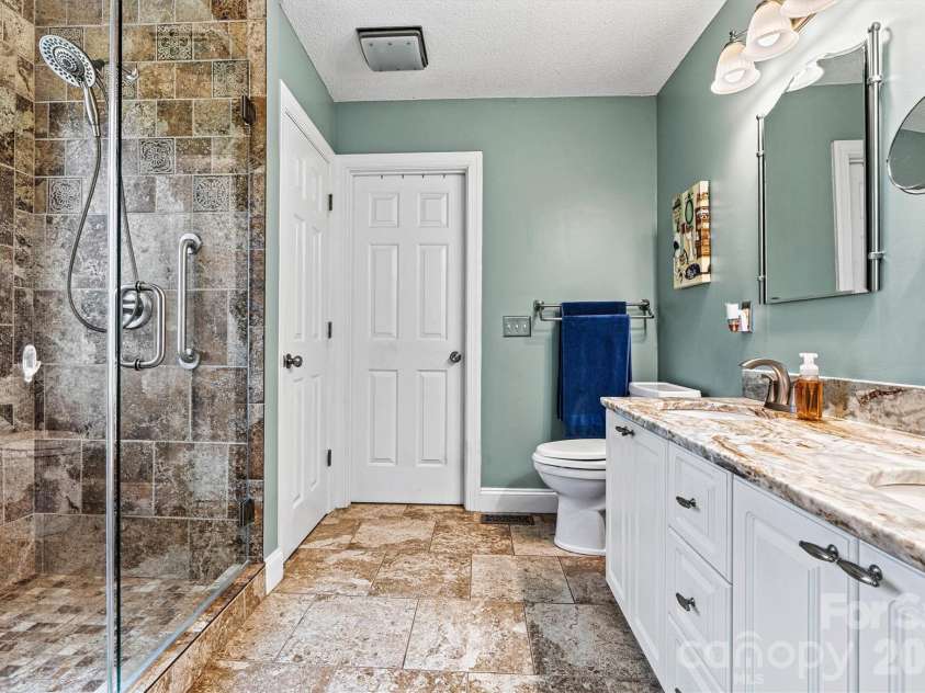 7538 Golf Course Drive, Denver, NC 28037.  MLS# CAR4375183, YatesRealty ID 28863. Tiled, updated primary ensuite bath with new granite countertop