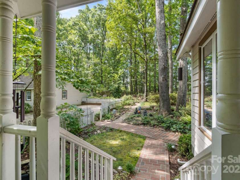 110 Amanda Drive, Matthews, NC 28104.  MLS# CAR4280480, YatesRealty ID 28865. Brick paved path leads to back and side yard