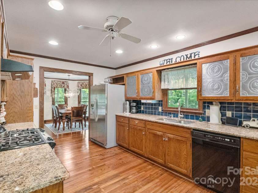 110 Amanda Drive, Matthews, NC 28104.  MLS# CAR4280480, YatesRealty ID 28865. Hand made cabinets with punch-tin accents add to the charm of this space