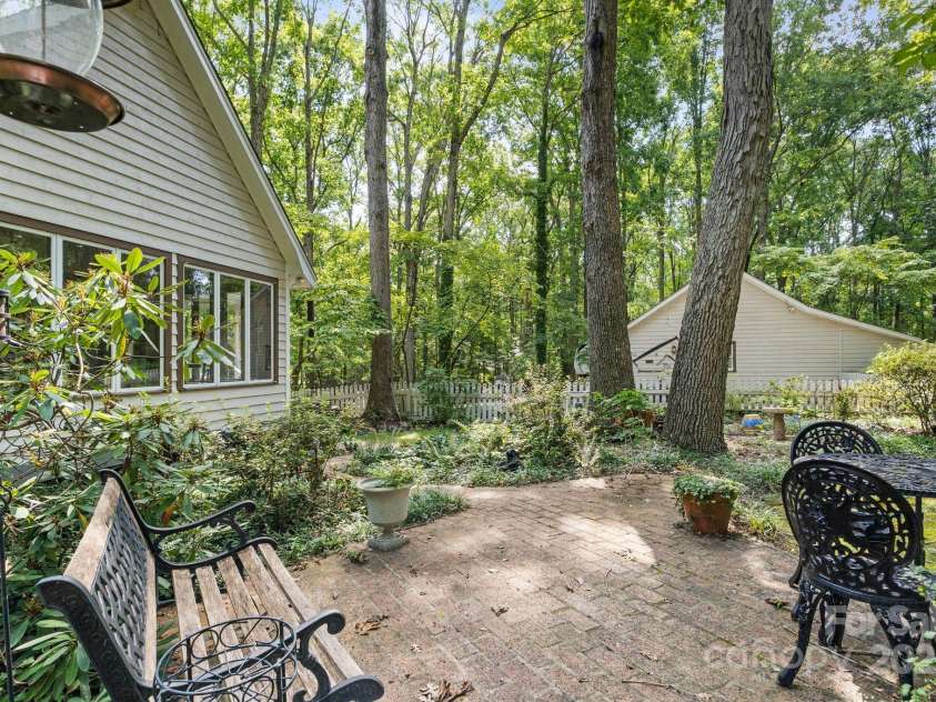 110 Amanda Drive, Matthews, NC 28104.  MLS# CAR4280480, YatesRealty ID 28865. Patio seating under the trees