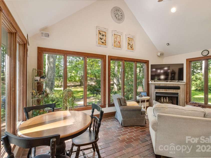 110 Amanda Drive, Matthews, NC 28104.  MLS# CAR4280480, YatesRealty ID 28865. Sunroom offers views of the backyard and access to the porch-Fireplace for decorative purposes only