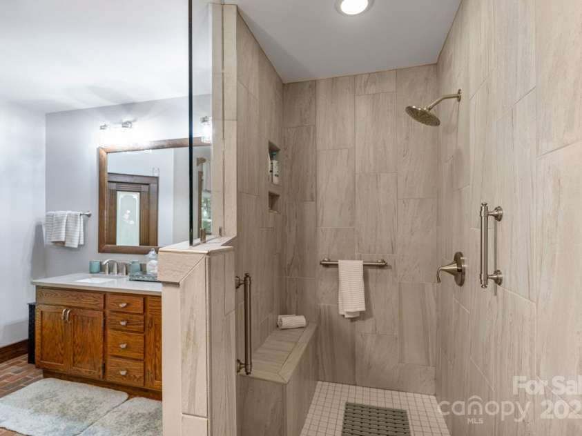 110 Amanda Drive, Matthews, NC 28104.  MLS# CAR4280480, YatesRealty ID 28865. Walk in tiled shower with bench