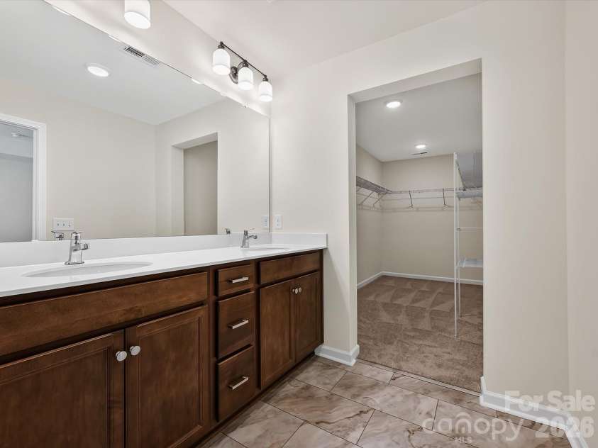 6543 Fire Lily Lane, Charlotte, NC 28216.  MLS# CAR4351859, YatesRealty ID 28876. Owner's Bath Leading into the Massive Owner's Closet