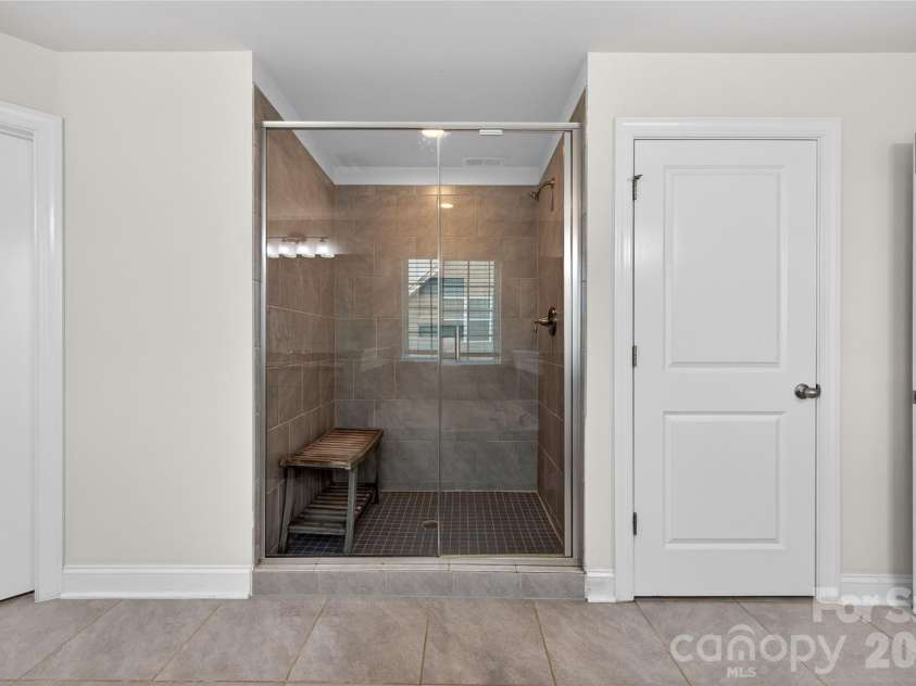 6216 Artigas Drive, Fort Mill, SC 29707.  MLS# CAR4380833, YatesRealty ID 28883. Glass Enclosed Tile Shower