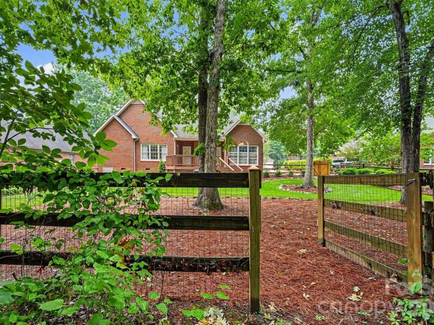 1320 Mill Race Lane, Matthews, NC 28104.  MLS# CAR4384297, YatesRealty ID 28900. Backyard view from trails