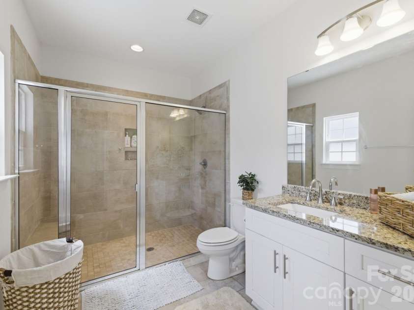 2176 Moss Meadow Lane, Denver, NC 28037.  MLS# CAR4387081, YatesRealty ID 28909. Primary bath with white cabinets, tile flooring and oversized tile shower
