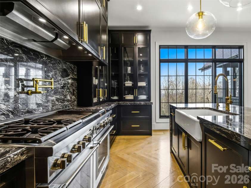 241 Tower Circle, Hendersonville, NC 28739.  MLS# CAR4346762, YatesRealty ID 2892. Chef’s kitchen with professional-grade range, granite surfaces, and custom storage throughout
