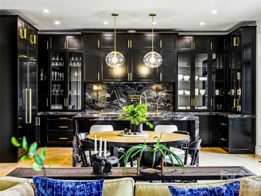 241 Tower Circle, Hendersonville, NC 28739.  MLS# CAR4346762, YatesRealty ID 2892. Designer kitchen with custom black cabinetry, granite backsplash, and statement lighting