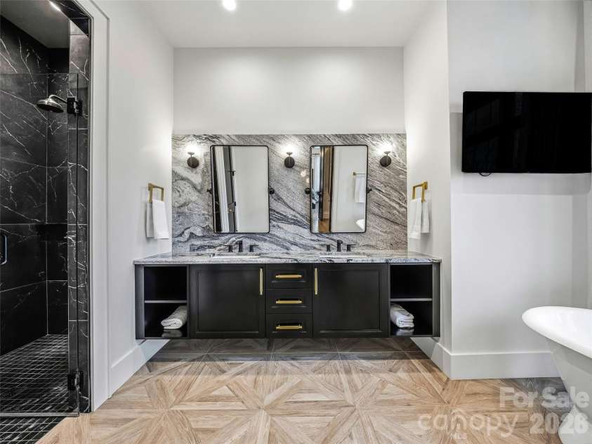 241 Tower Circle, Hendersonville, NC 28739.  MLS# CAR4346762, YatesRealty ID 2892. Primary bath with oversized dual vanity, statement mirrors, and sleek modern finishes
