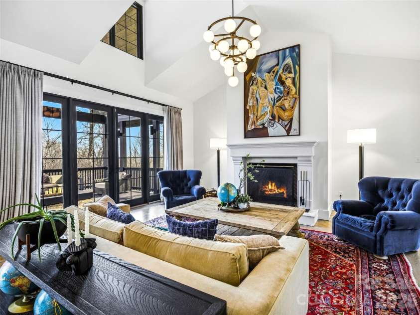 241 Tower Circle, Laurel Park, NC 28739.  MLS# CAR4346762, YatesRealty ID 2892. Floor-to-ceiling windows and French doors open to the covered deck for seamless indoor-outdoor living.