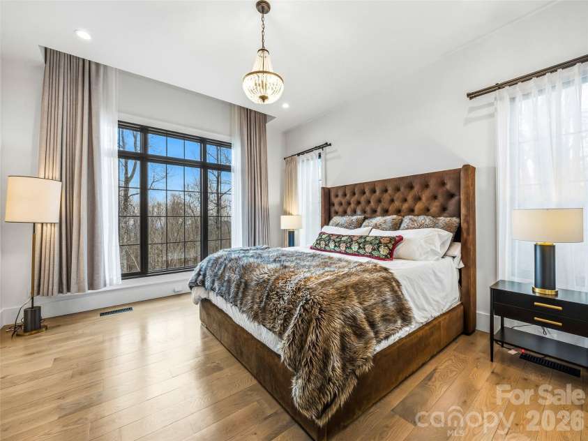 241 Tower Circle, Laurel Park, NC 28739.  MLS# CAR4346762, YatesRealty ID 2892. Light-filled primary suite with large windows and elegant finishes