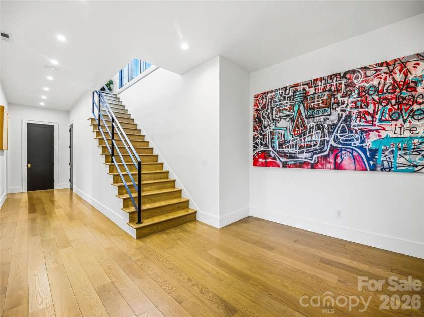 241 Tower Circle, Laurel Park, NC 28739.  MLS# CAR4346762, YatesRealty ID 2892. Lower-level entry with hardwood floors, modern staircase, and clean architectural lines