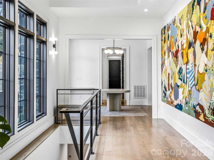 241 Tower Circle, Laurel Park, NC 28739.  MLS# CAR4346762, YatesRealty ID 2892. Open hallway highlighted by oversized windows and contemporary architectural lines.