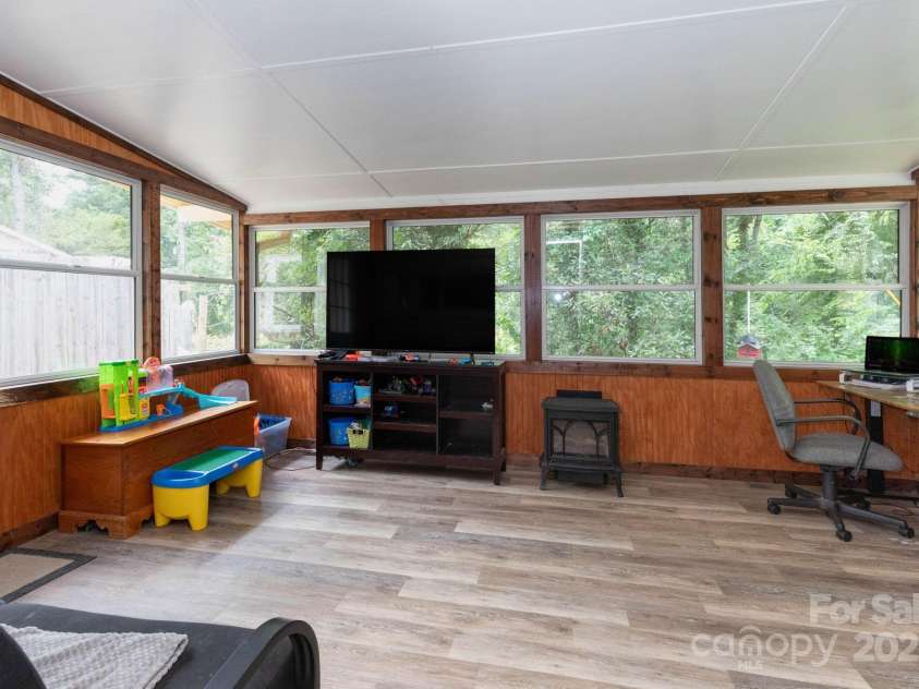 229 Ewart Drive, Hendersonville, NC 28739.  MLS# CAR4276443, YatesRealty ID 28930. Heated sunroom with natural gas fire place.