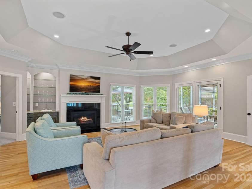 17308 Players Ridge Drive, Cornelius, NC 28031.  MLS# CAR4261359, YatesRealty ID 28986. Lovely living room with gas log fireplace and lots of natural light.