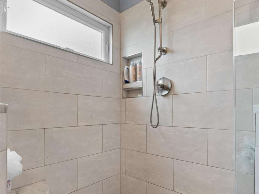 230 Fairway Falls Road, Mills River, NC 28759.  MLS# CAR4256641, YatesRealty ID 29061. Spacious primary shower with tiled floor and walls, Frameless glass shower door.