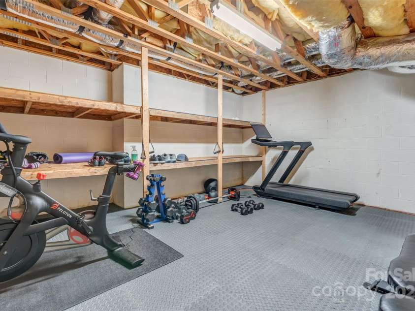 230 Fairway Falls Road, Mills River, NC 28759.  MLS# CAR4256641, YatesRealty ID 29061. Storage and Workout Room in unfinished part of Basement