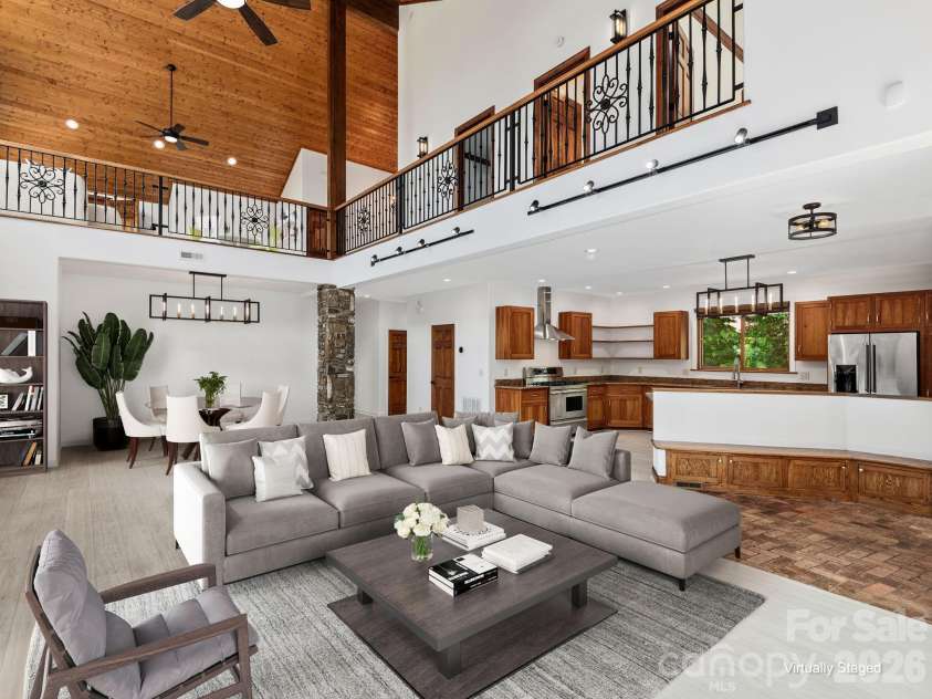 248 Wisdom Cove Road, Flat Rock, NC 28731.  MLS# CAR4357941, YatesRealty ID 29067. Open Great Room w/Dining, Kitchen, Half Bath. Virtually staged.