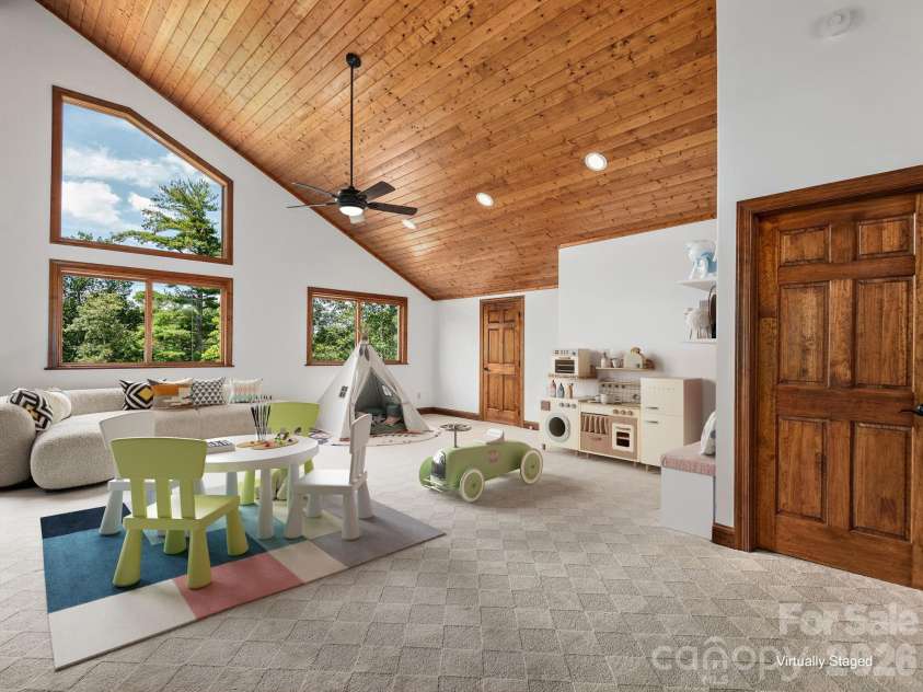 248 Wisdom Cove Road, Flat Rock, NC 28731.  MLS# CAR4357941, YatesRealty ID 29067. Upper Level Loft area. Far door is interior storage and easy access to upper level hvac. Virtually staged.