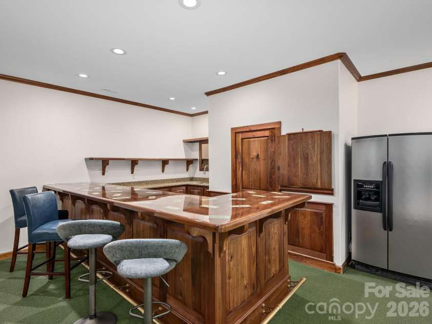 248 Wisdom Cove Road, Flat Rock, NC 28731.  MLS# CAR4413753, YatesRealty ID 29067. Full Entertaining Bar w/full size refrigerator and storage room.