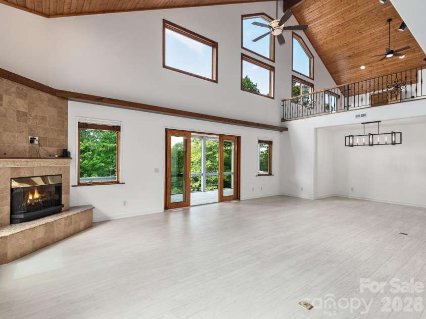 248 Wisdom Cove Road, Flat Rock, NC 28731.  MLS# CAR4413753, YatesRealty ID 29067. Open Great Room, Dining, Screen Porch access.