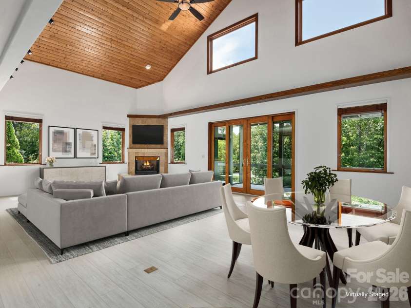 248 Wisdom Cove Road, Flat Rock, NC 28731.  MLS# CAR4413753, YatesRealty ID 29067. Open Great Room, Living, Dining, Screen Porch access. Virtually staged.
