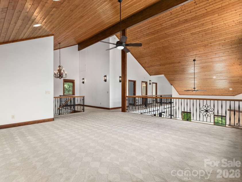 248 Wisdom Cove Road, Flat Rock, NC 28731.  MLS# CAR4413753, YatesRealty ID 29067. Upper Level Loft area. View to two bedrooms and full bathroom.