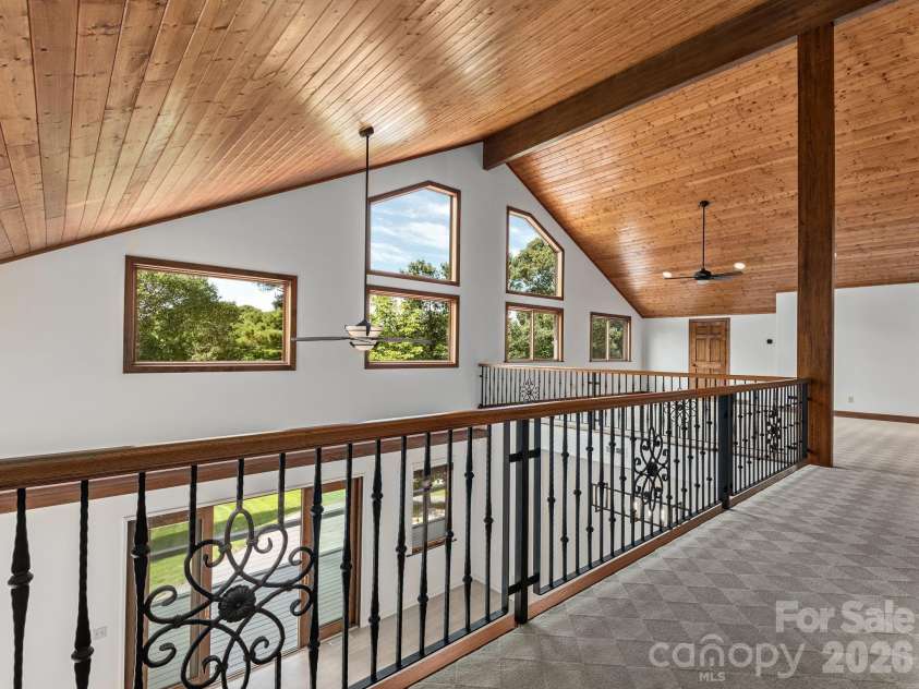248 Wisdom Cove Road, Flat Rock, NC 28731.  MLS# CAR4413753, YatesRealty ID 29067. View to upper level loft area from two bedrooms. Beautiful windows lets in the light.