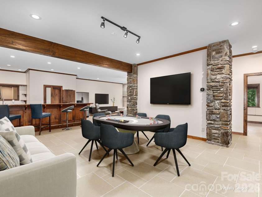 248 Wisdom Cove Road, Flat Rock, NC 28731.  MLS# CAR4413753, YatesRealty ID 29067. Virtually staged basement showing similar tile that is under the golf carpet.