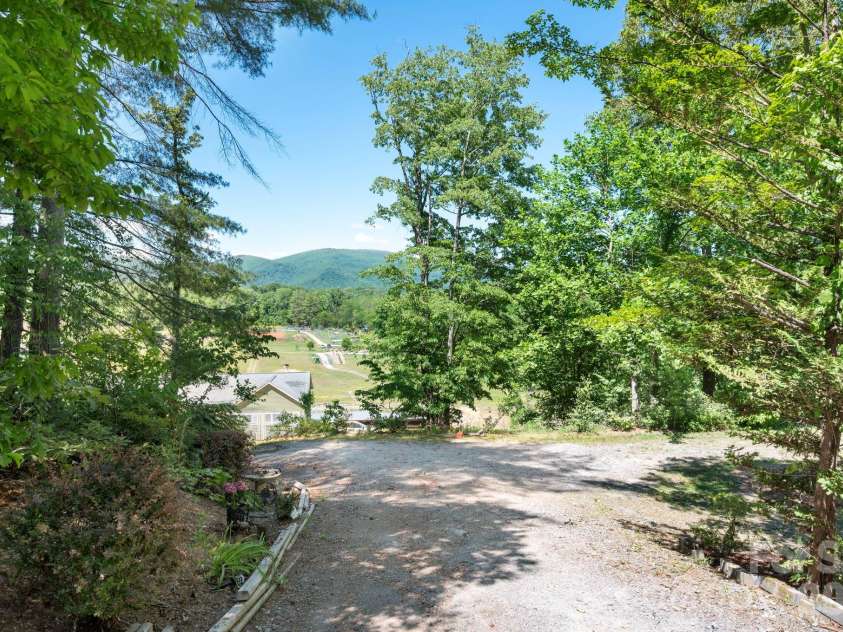 43 Charles Marlowe Drive, Fairview, NC 28730.  MLS# CAR4385183, YatesRealty ID 29070. Looking back towards the access road, charming setting with Root Cause Farm down below, to the right is the parking area for the lower level.