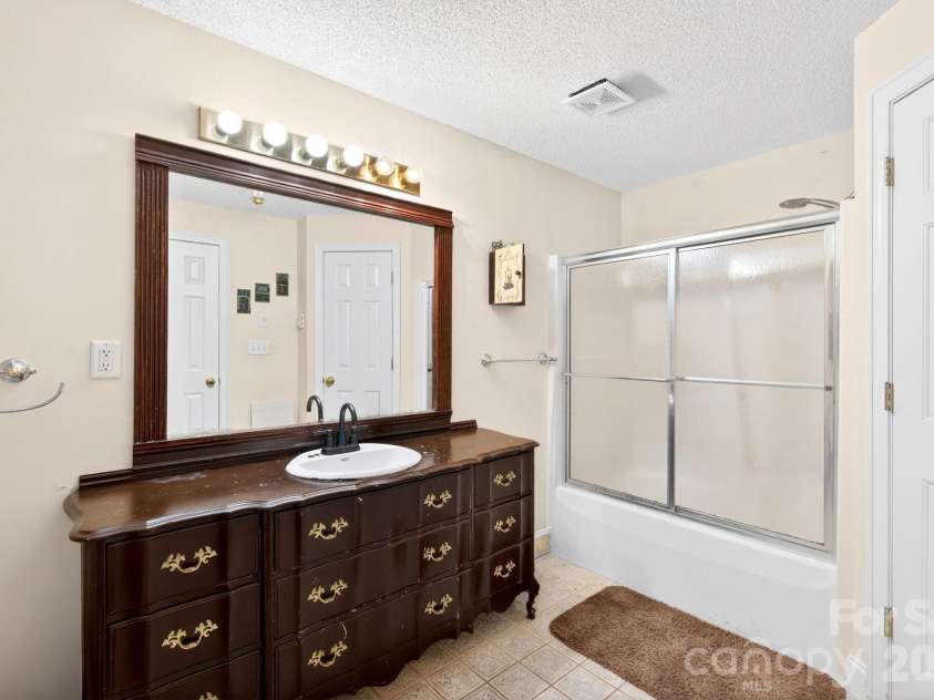43 Charles Marlowe Drive, Fairview, NC 28730.  MLS# CAR4385183, YatesRealty ID 29070. One of two full lower bathrooms.