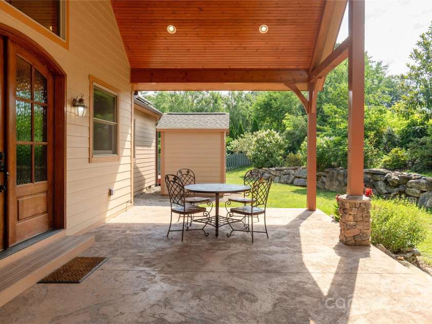 32 Pine Acre Boulevard, Asheville, NC 28804.  MLS# CAR4283589, YatesRealty ID 29077. View of back patio and storage