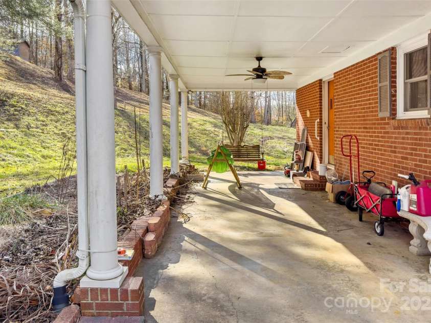 80 Robinson Holler Drive, Marion, NC 28752.  MLS# CAR4112689, YatesRealty ID 29090. Covered and attached carpart/ patio. Could be a screened in porch or easily more heated living space if desired.