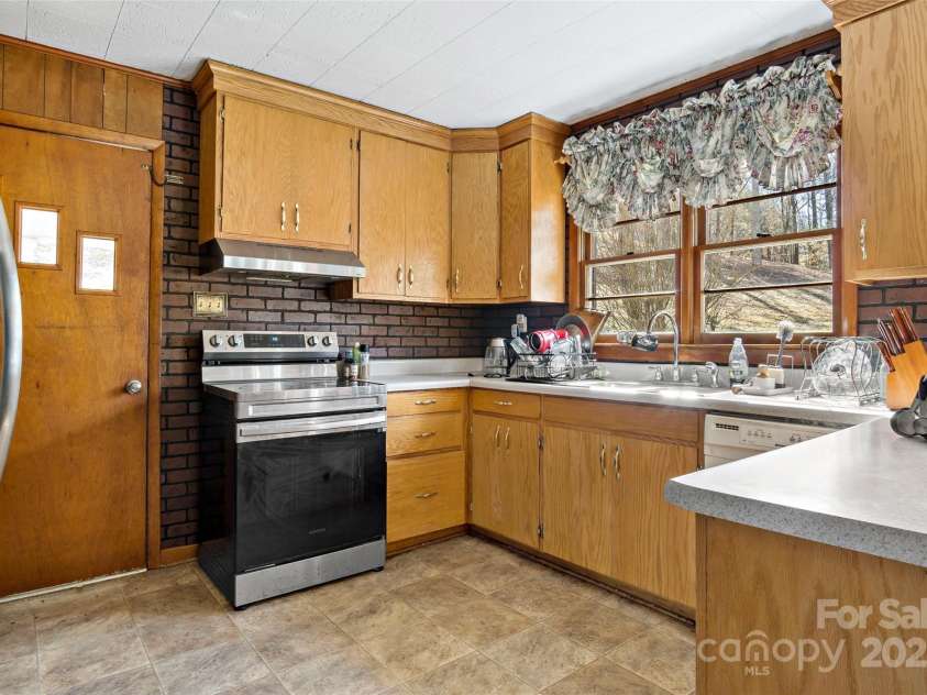 80 Robinson Holler Drive, Marion, NC 28752.  MLS# CAR4112689, YatesRealty ID 29090. Kitchen has ample cabinets and side entry from carport.